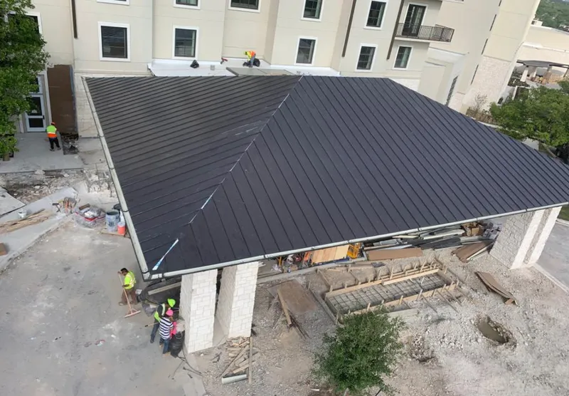 Metal roofing installation team working on a commercial building in Mount Laurel